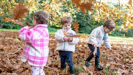 3 children playing in the oak leaves